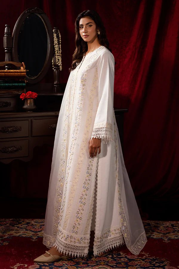 Model wearing a white Pearlescent dress from Saffron, adorned with intricate embroidery, ideal for winter, showcasing Pakistani designer clothes online in the UK.