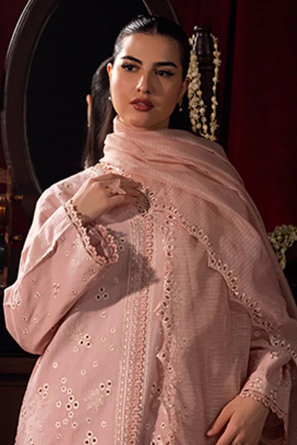 Model wearing a soft pink Petal Mist dress from Saffron, adorned with delicate embroidery, showcasing Pakistani designer clothes online in the UK, perfect for winter.