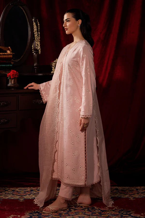 Model wearing a soft pink Petal Mist dress from Saffron, adorned with delicate embroidery, showcasing Pakistani designer clothes online in the UK, perfect for winter.