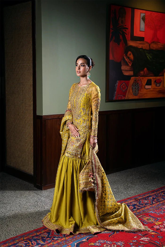 Model wearing Saira Rizwan Festive Formals '24 SERA - SRF - D - 08, a mustard yellow embellished outfit with traditional design, ideal for weddings. Available as Pakistani clothes online in the UK.