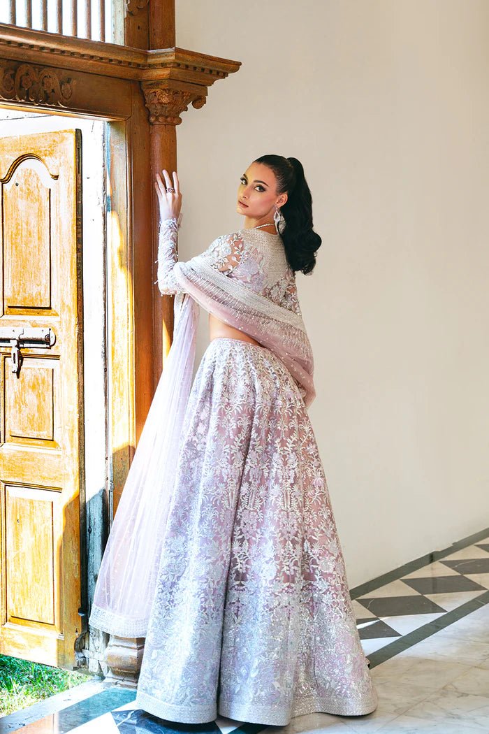 Model wearing a light pink lehenga choli from Saira Rizwan's Naqsh Festive '24 collection, SRN24 - 03 FRANCESCA. Perfect for weddings, this dress is available at Signature Labels Pakistani clothes online in UK.