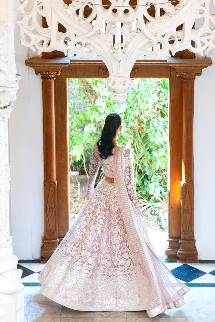 Model wearing a light pink lehenga choli from Saira Rizwan's Naqsh Festive '24 collection, SRN24 - 03 FRANCESCA. Perfect for weddings, this dress is available at Signature Labels Pakistani clothes online in UK.