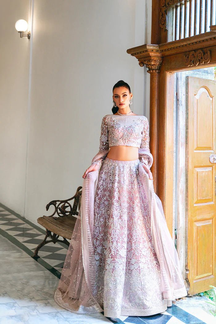 Model wearing a light pink lehenga choli from Saira Rizwan's Naqsh Festive '24 collection, SRN24 - 03 FRANCESCA. Perfect for weddings, this dress is available at Signature Labels Pakistani clothes online in UK.