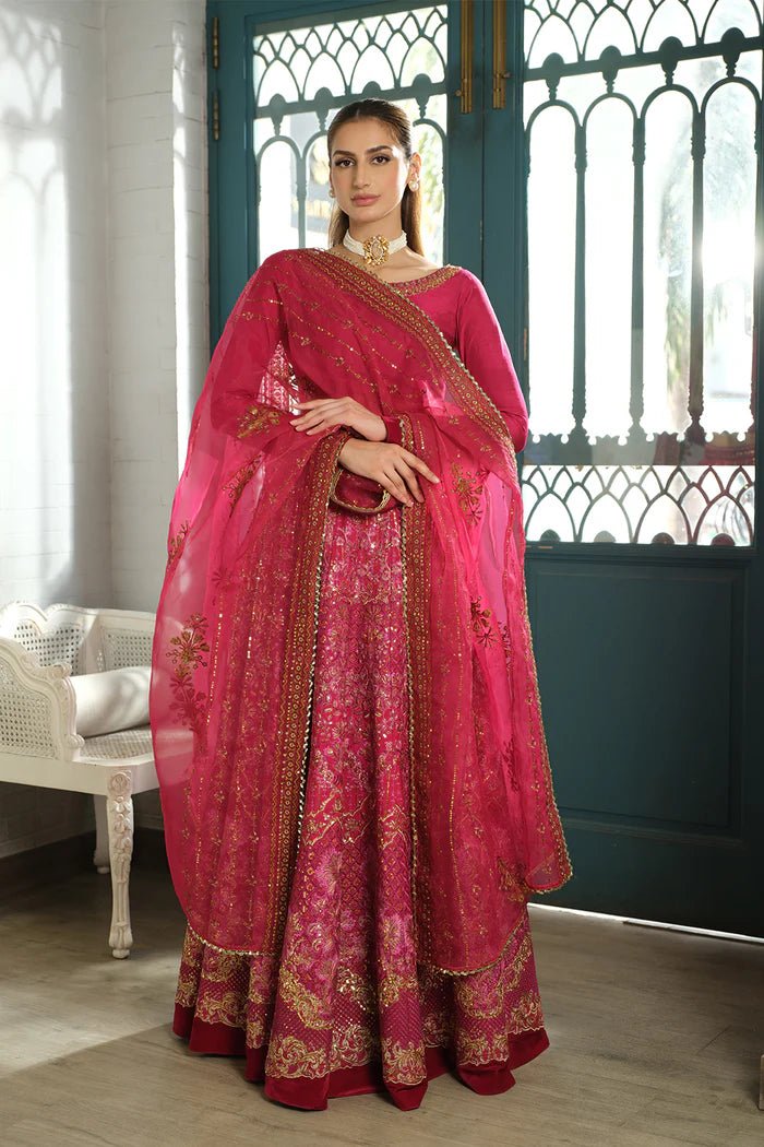 Model wearing a red SRN24 - 04 SHARMAS lehenga choli from Saira Rizwan's Naqsh Festive '24 collection. Available online in the UK, perfect for weddings.