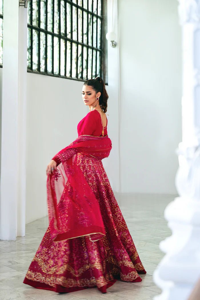 Model wearing a red SRN24 - 04 SHARMAS lehenga choli from Saira Rizwan's Naqsh Festive '24 collection. Available online in the UK, perfect for weddings.