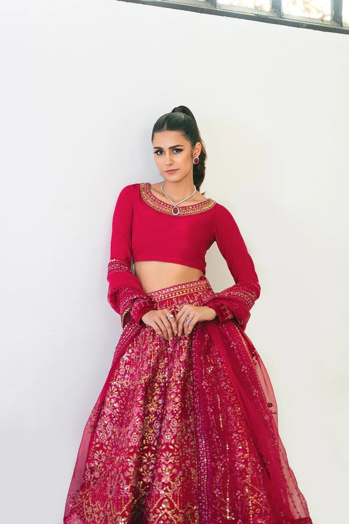 Model wearing a red SRN24 - 04 SHARMAS lehenga choli from Saira Rizwan's Naqsh Festive '24 collection. Available online in the UK, perfect for weddings.