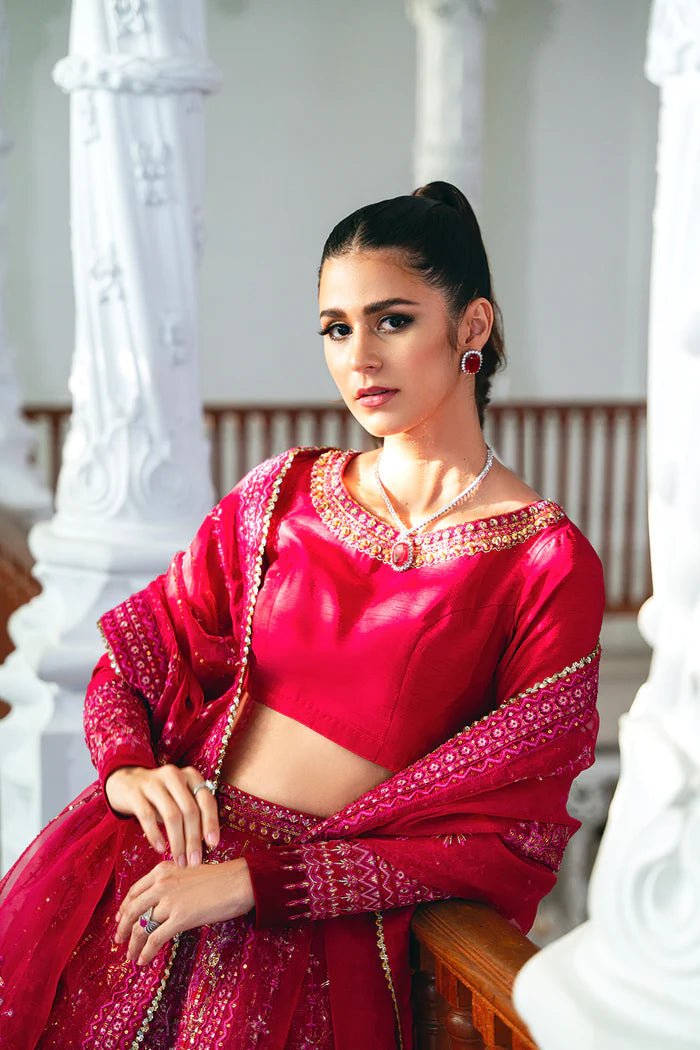 Model wearing a red SRN24 - 04 SHARMAS lehenga choli from Saira Rizwan's Naqsh Festive '24 collection. Available online in the UK, perfect for weddings.