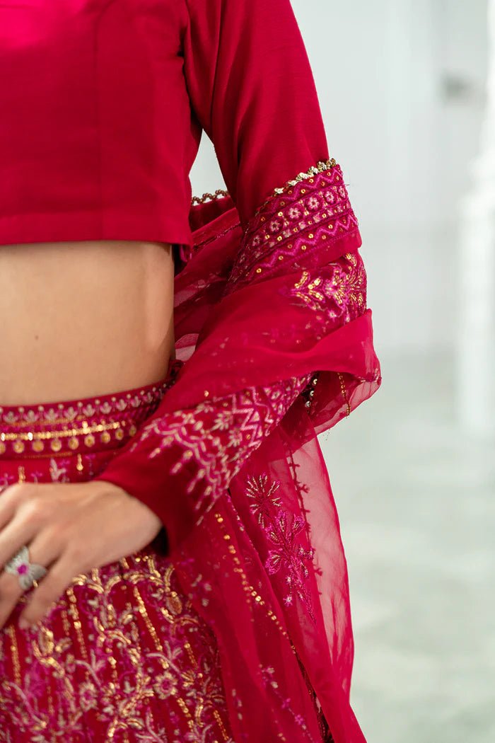 Model wearing a red SRN24 - 04 SHARMAS lehenga choli from Saira Rizwan's Naqsh Festive '24 collection. Available online in the UK, perfect for weddings.