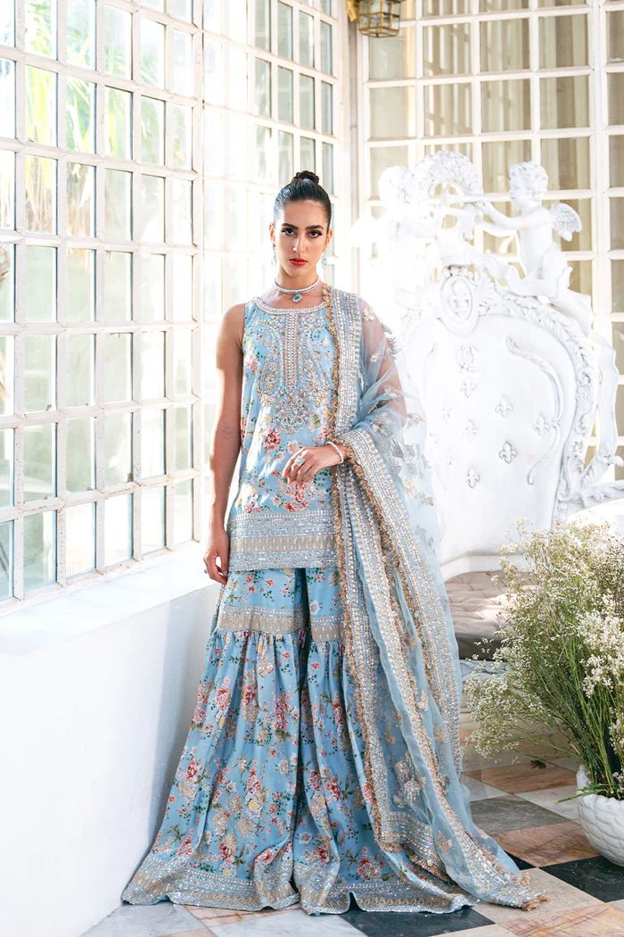 Model wearing SRN24 - 05 EDWINA dress in light blue with intricate floral embroidery from Saira Rizwan, showcasing Pakistani wedding clothes available online in the UK.