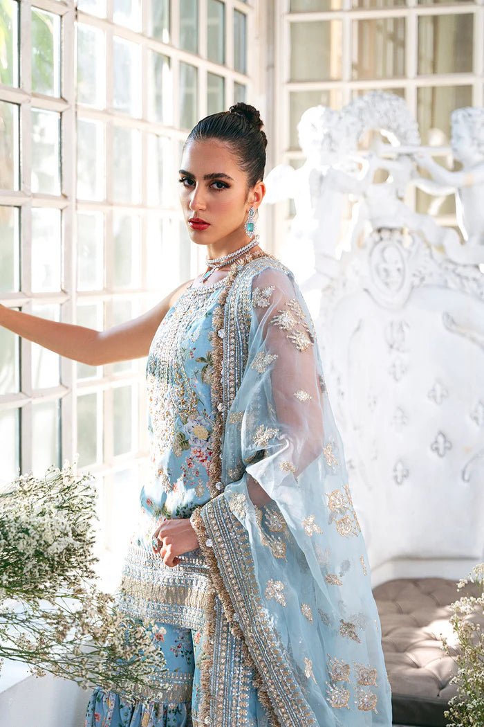 Model wearing SRN24 - 05 EDWINA dress in light blue with intricate floral embroidery from Saira Rizwan, showcasing Pakistani wedding clothes available online in the UK.