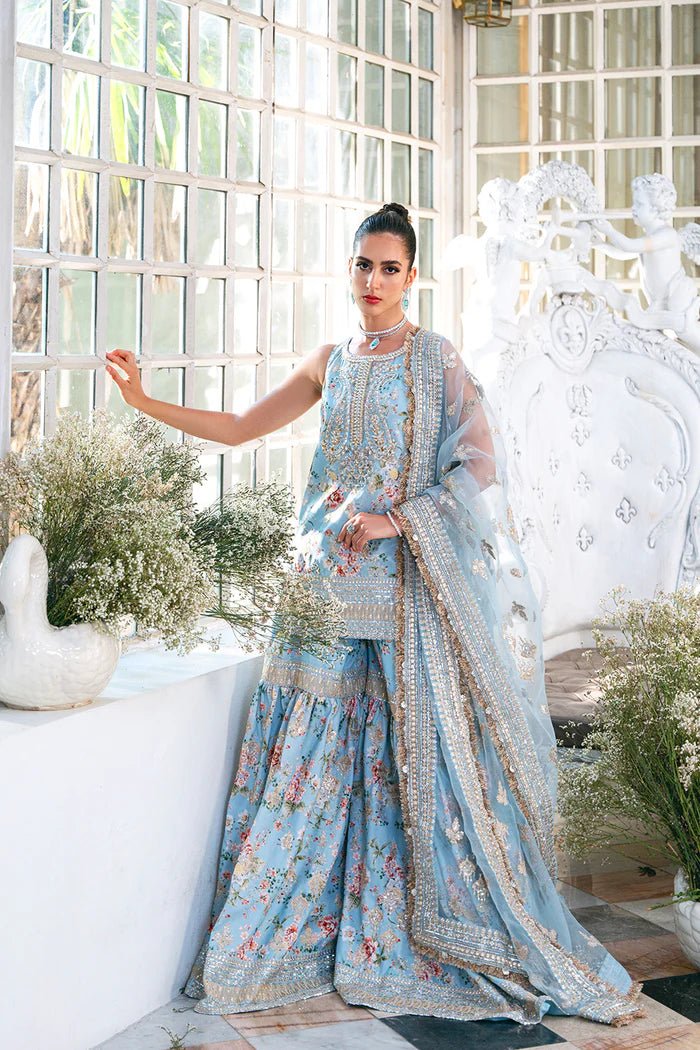 Model wearing SRN24 - 05 EDWINA dress in light blue with intricate floral embroidery from Saira Rizwan, showcasing Pakistani wedding clothes available online in the UK.