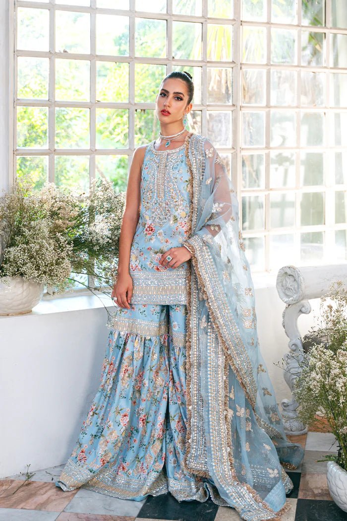 Model wearing SRN24 - 05 EDWINA dress in light blue with intricate floral embroidery from Saira Rizwan, showcasing Pakistani wedding clothes available online in the UK.