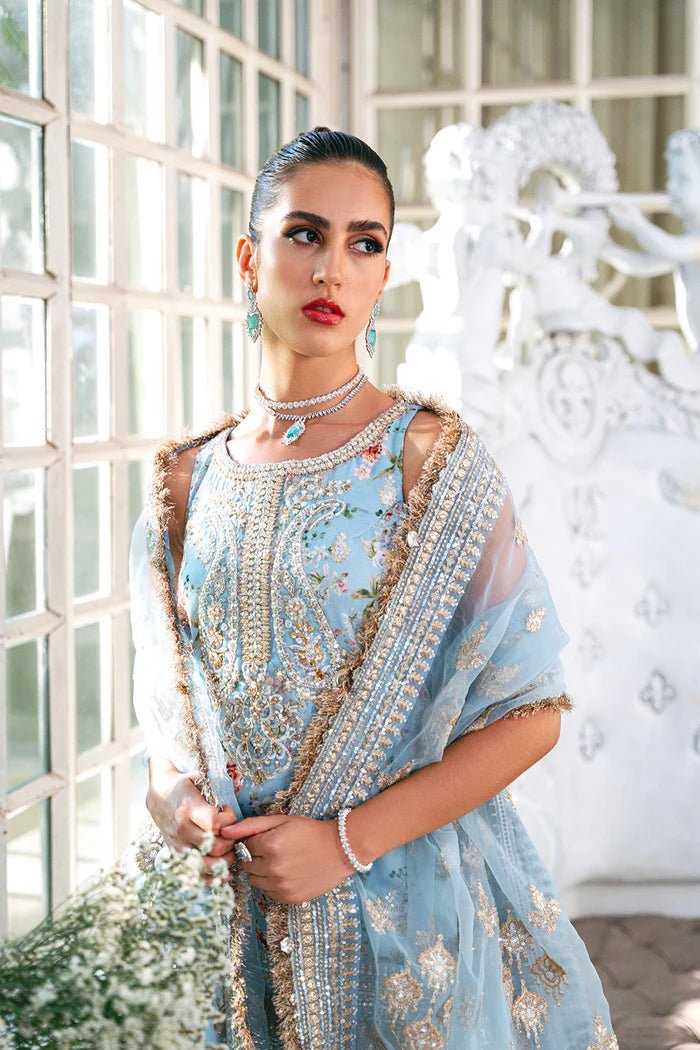 Model wearing SRN24 - 05 EDWINA dress in light blue with intricate floral embroidery from Saira Rizwan, showcasing Pakistani wedding clothes available online in the UK.