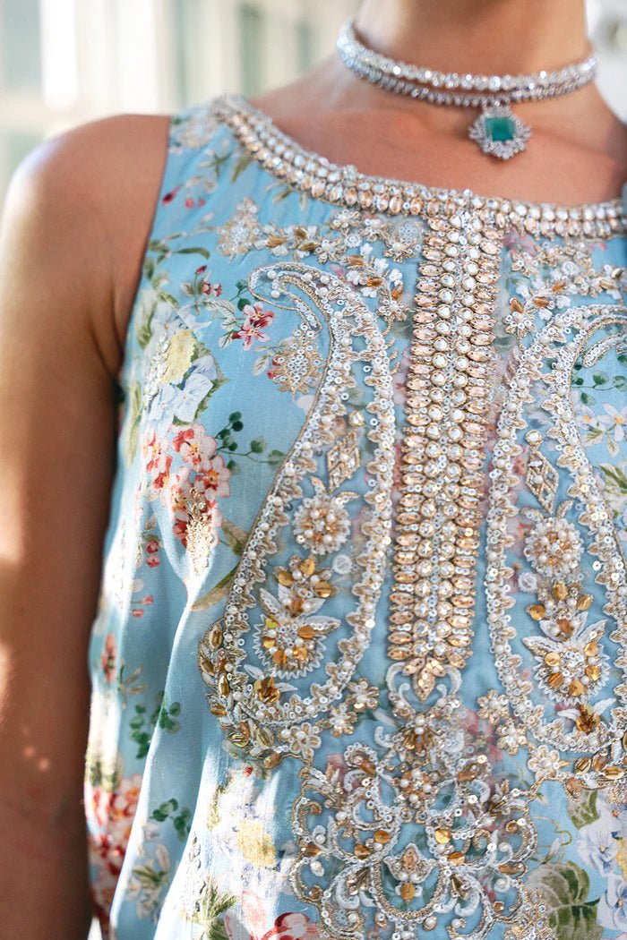 Model wearing SRN24 - 05 EDWINA dress in light blue with intricate floral embroidery from Saira Rizwan, showcasing Pakistani wedding clothes available online in the UK.