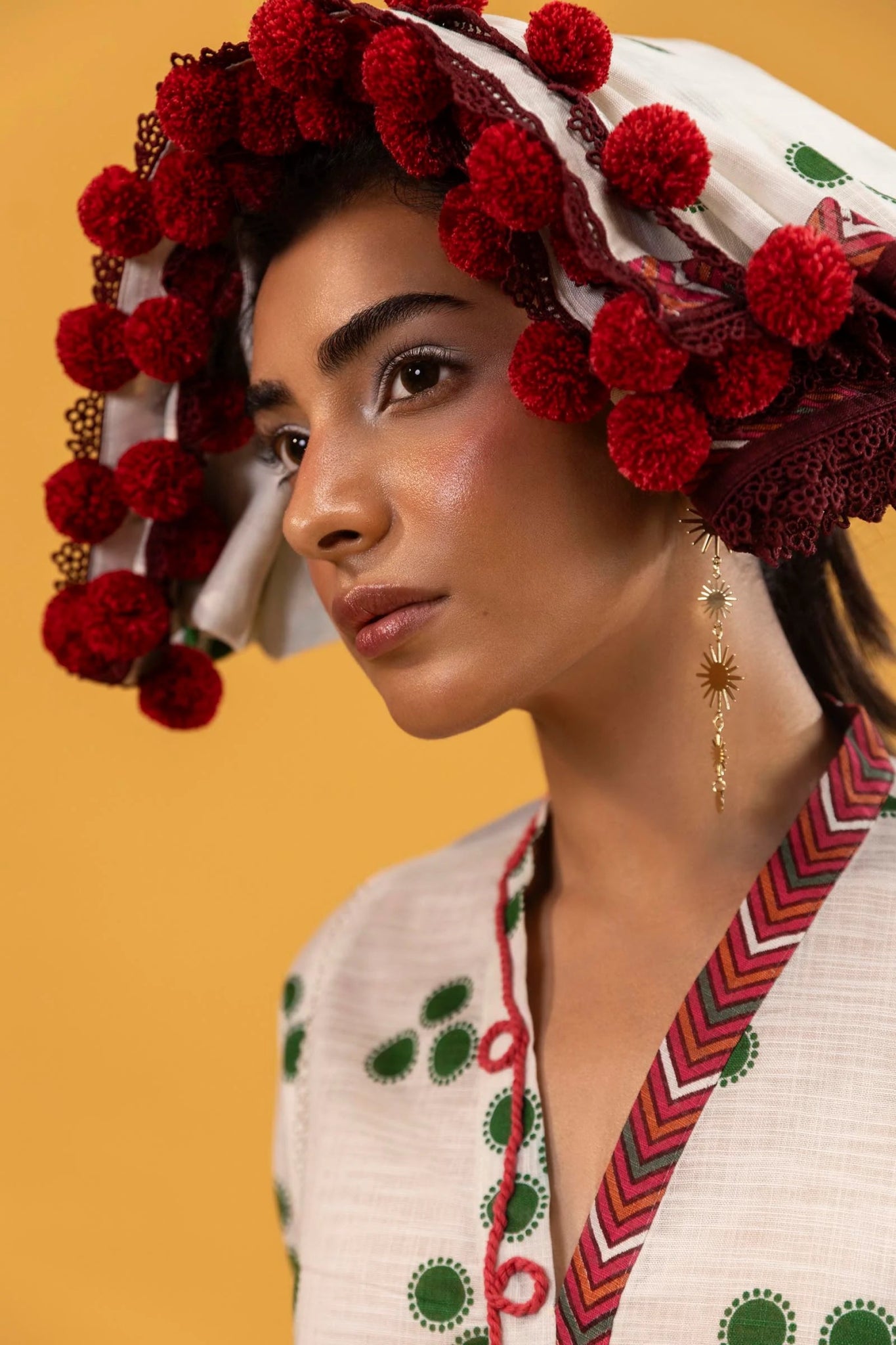 Model wearing Sana Safinaz Mahay Winter '24, showcasing a white and yellow with hues of green 3 - piece outfit with embroidery and intricate printing, ideal for winter casual pret. Available online in the UK.