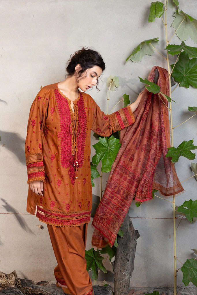 Model wearing Sobia Nazir Fall Edit '24 Design 7A, featuring a brown outfit with intricate embroidery, perfect for winter casual pret. Available online in the UK.