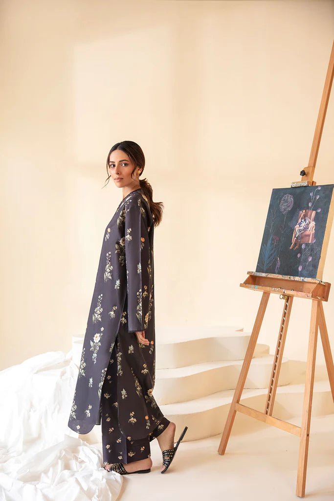 Model wearing Sobia Nazir Fall Edit '24 SNPP - 0321, showcasing a black outfit with detailed embroidery, ideal for winter casual pret. Available online in the UK.