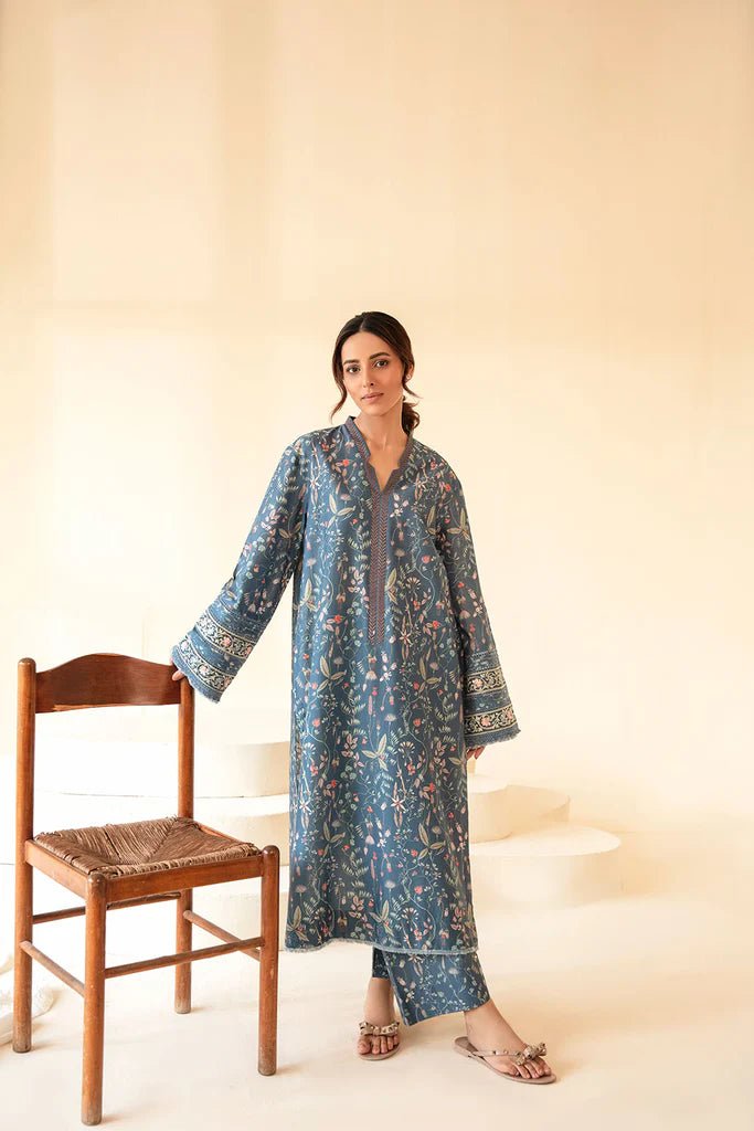 Model wearing Sobia Nazir Fall Edit '24 SNPP - 0323, featuring a blue outfit with intricate embroidery, perfect for winter casual pret. Available online in the UK.