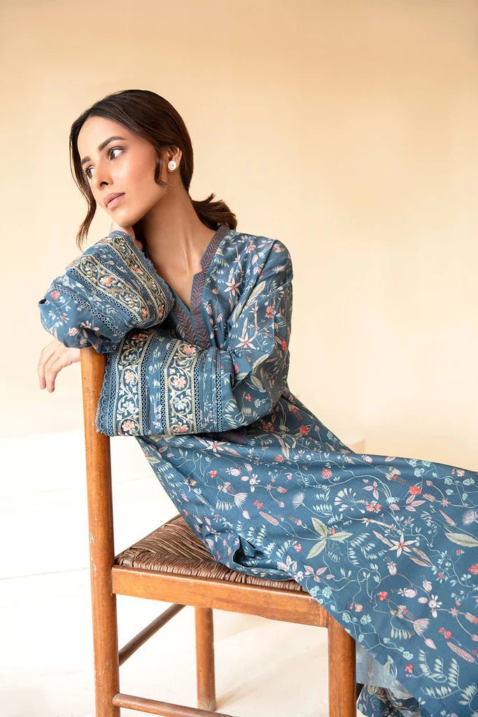 Model wearing Sobia Nazir Fall Edit '24 SNPP - 0323, featuring a blue outfit with intricate embroidery, perfect for winter casual pret. Available online in the UK.