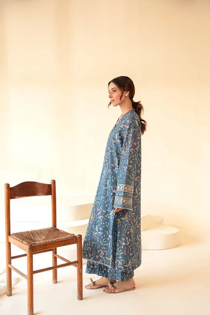 Model wearing Sobia Nazir Fall Edit '24 SNPP - 0323, featuring a blue outfit with intricate embroidery, perfect for winter casual pret. Available online in the UK.