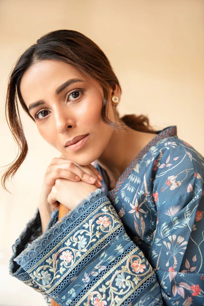 Model wearing Sobia Nazir Fall Edit '24 SNPP - 0323, featuring a blue outfit with intricate embroidery, perfect for winter casual pret. Available online in the UK.