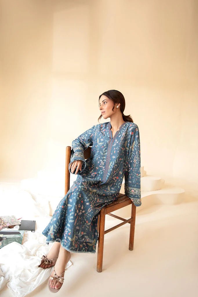 Model wearing Sobia Nazir Fall Edit '24 SNPP - 0323, featuring a blue outfit with intricate embroidery, perfect for winter casual pret. Available online in the UK.