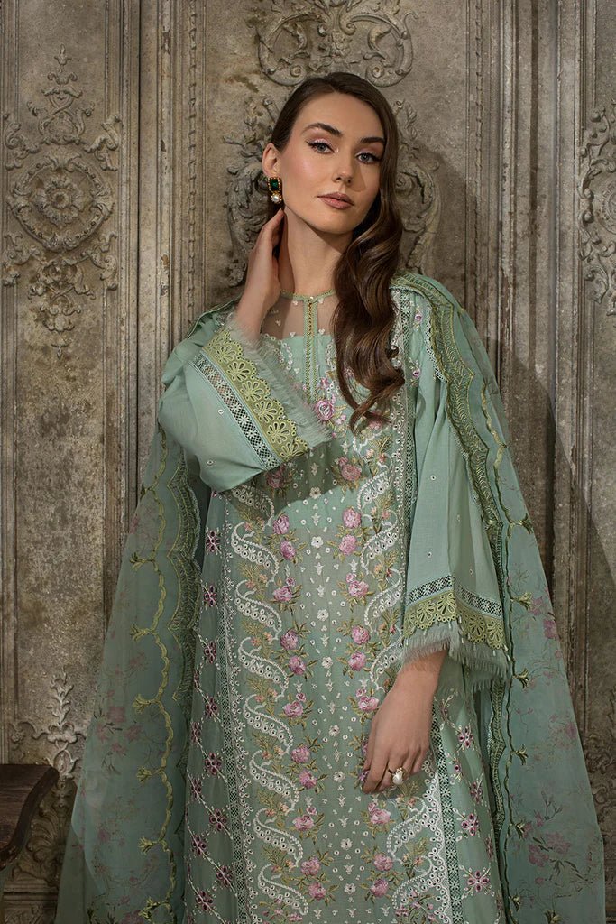 Model in Sobia Nazir DESIGN 1A, elegant green Pakistani lawn attire, sought - after in the UK.