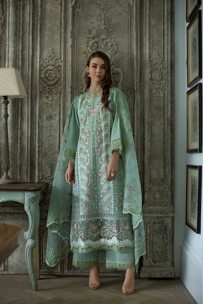 Model in Sobia Nazir DESIGN 1A, elegant green Pakistani lawn attire, sought - after in the UK.