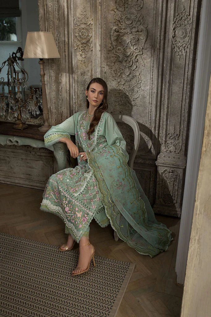 Model in Sobia Nazir DESIGN 1A, elegant green Pakistani lawn attire, sought - after in the UK.
