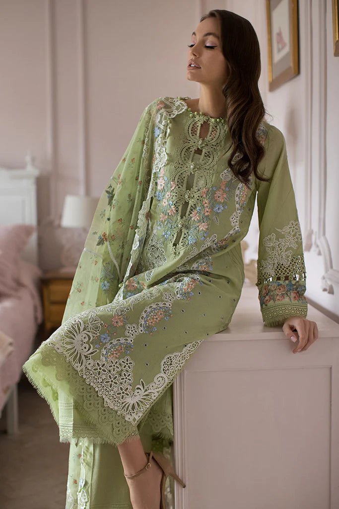 Model poses in Sobia Nazir DESIGN 4A, delicate green lawn suit, UK's Pakistani clothing choice.