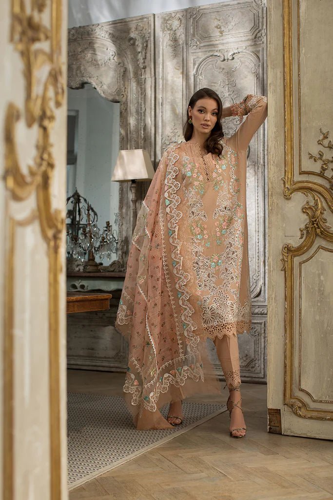 Model in a delicate Sobia Nazir DESIGN 4B lawn dress, showcasing Pakistani elegance in the UK.