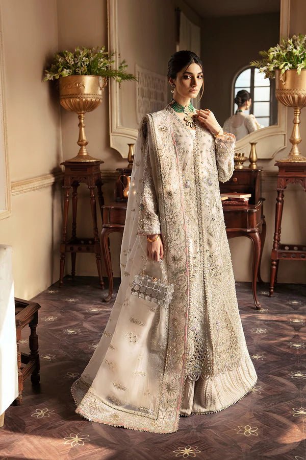 Model wearing a luxurious MIEL dress in silver by Soraya from the Lumene Festive '24 collection. Ideal for weddings and available online in the UK.