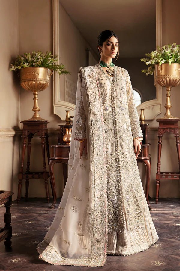 Model wearing a luxurious MIEL dress in silver by Soraya from the Lumene Festive '24 collection. Ideal for weddings and available online in the UK.