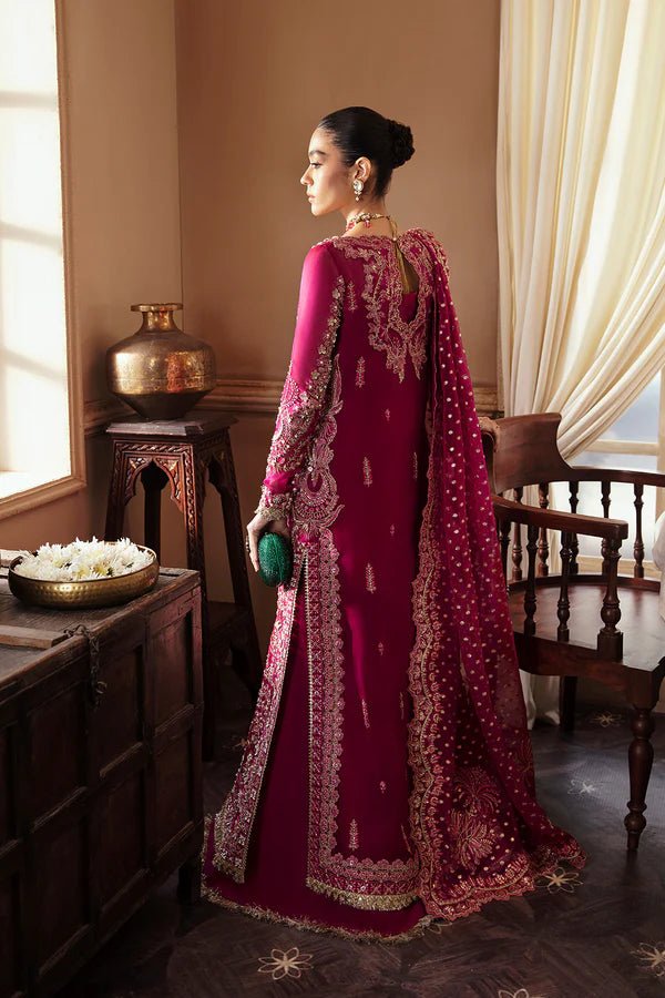 Model wearing RAIZEL dress in rich magenta from Soraya. Perfect for weddings, highlighting intricate embroidery and luxurious design. Buy Pakistani clothes online in UK from Soraya.