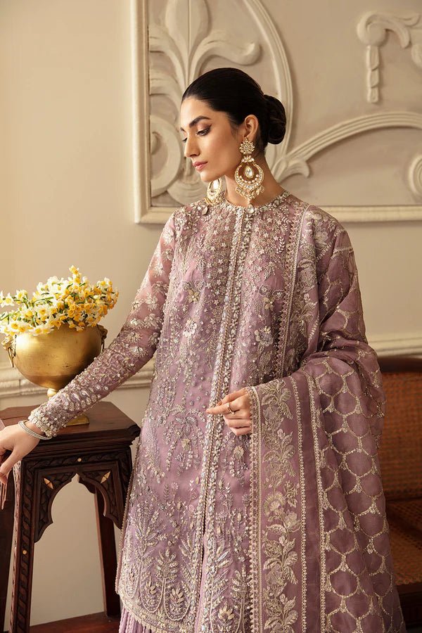 Model wearing a lavender Sehr dress from Soraya's Lumene Festive '24 collection. Perfect for weddings, shop Pakistani clothes online in the UK.