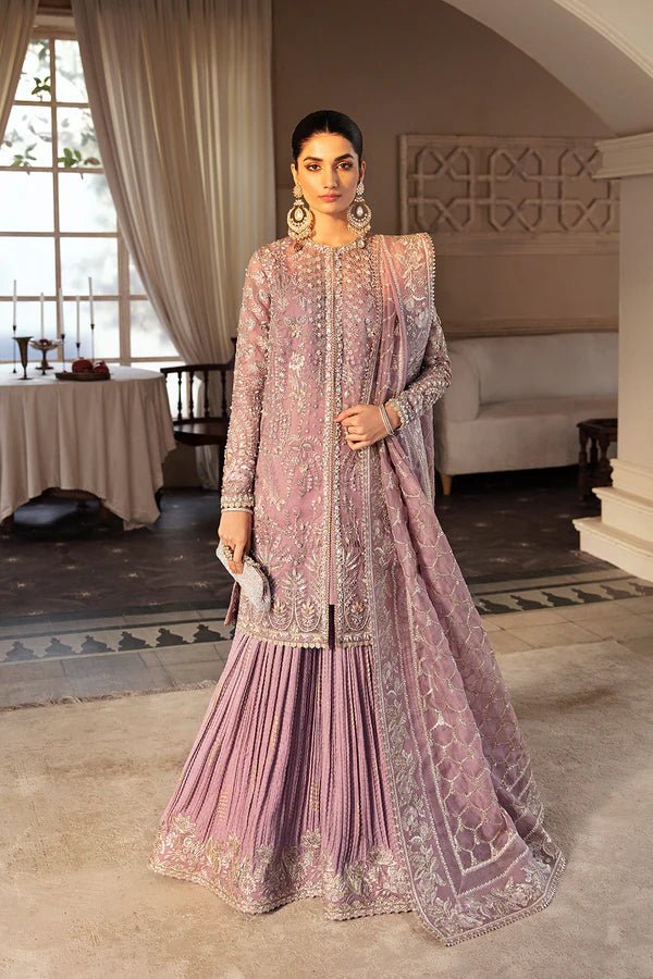 Model wearing a lavender Sehr dress from Soraya's Lumene Festive '24 collection. Perfect for weddings, shop Pakistani clothes online in the UK.