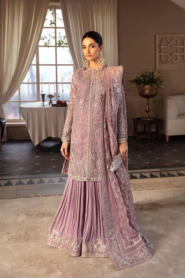 Model wearing a lavender Sehr dress from Soraya's Lumene Festive '24 collection. Perfect for weddings, shop Pakistani clothes online in the UK.