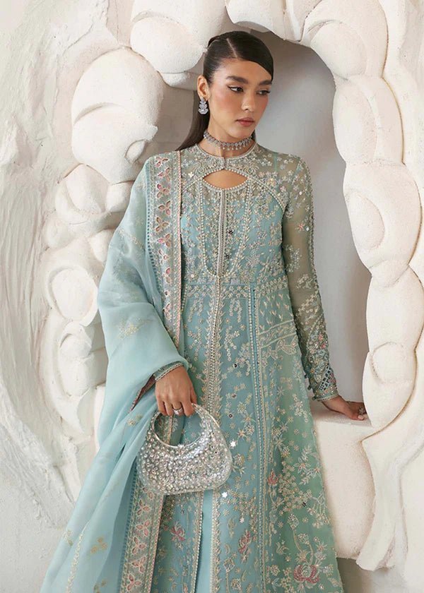 Model wearing a pastel ice blue Iyara dress with intricate embroidery from Suffuse's FREESHIA RTW '24 collection, ideal for weddings.