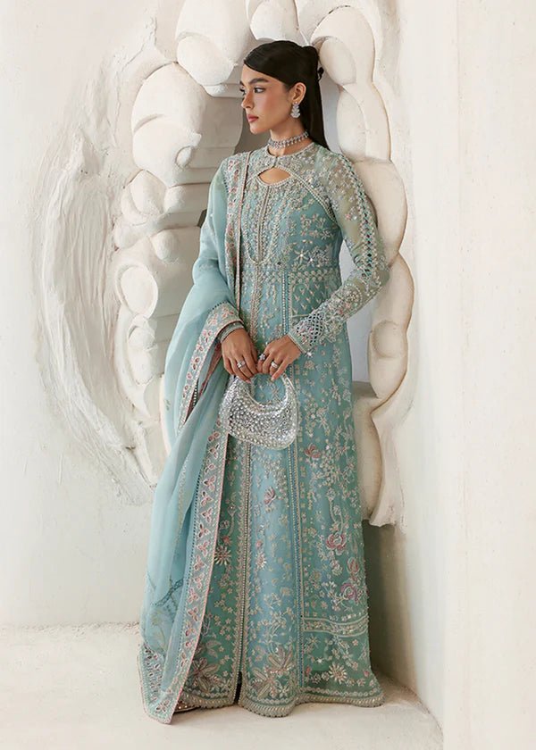 Model wearing a pastel ice blue Iyara dress with intricate embroidery from Suffuse's FREESHIA RTW '24 collection, ideal for weddings.