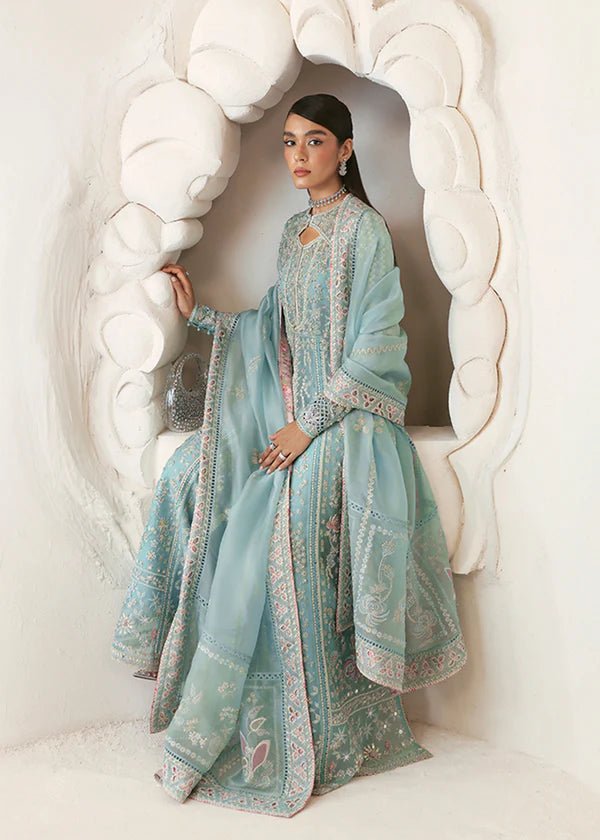 Model wearing a pastel ice blue Iyara dress with intricate embroidery from Suffuse's FREESHIA RTW '24 collection, ideal for weddings.