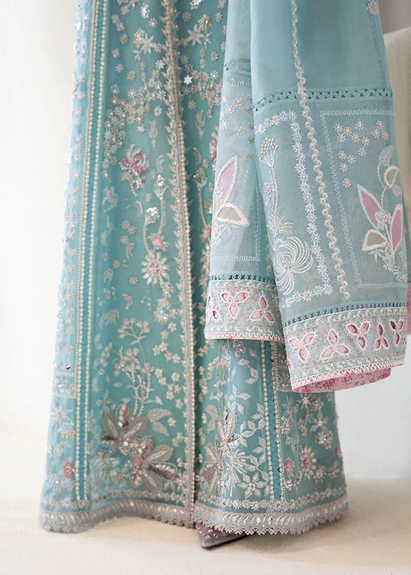 Model wearing a pastel ice blue Iyara dress with intricate embroidery from Suffuse's FREESHIA RTW '24 collection, ideal for weddings.