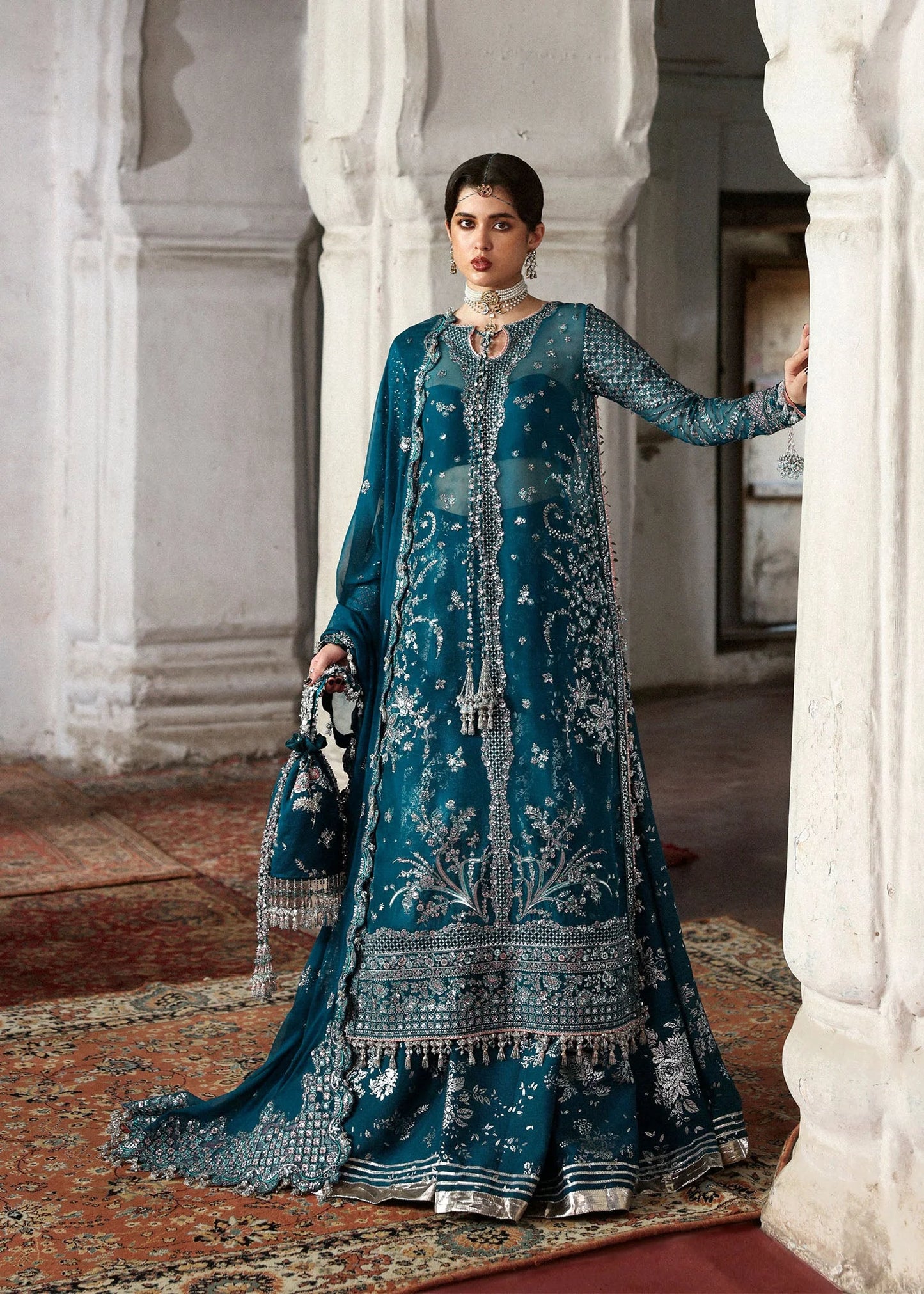 Model wearing deep teal Zebunisa by Hussain Rehar with intricate silver embroidery – Pakistani luxury pret, shop online in UK.