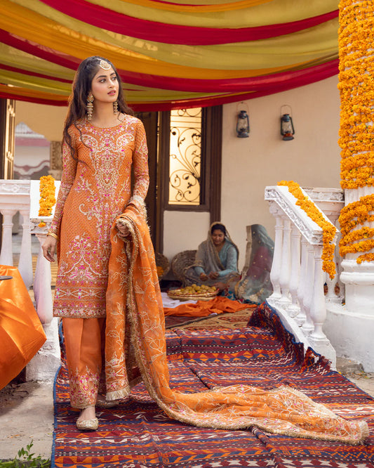 model wearing orange dress by Faiza Saqlain, Pakistani luxury pret ideal for online shopping in the UK
