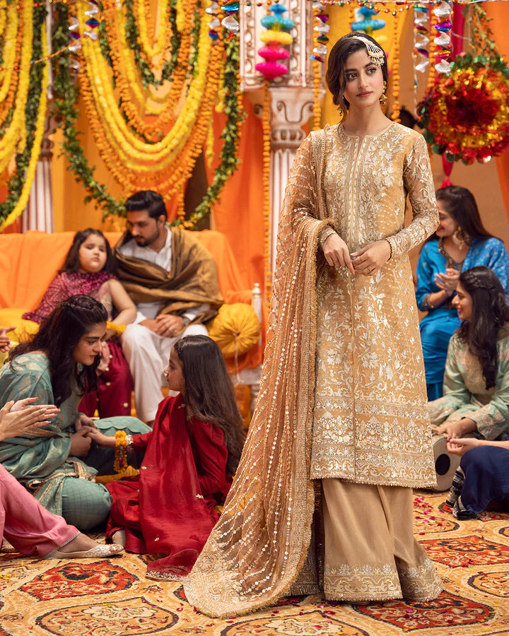 model wearing beige dress by Faiza Saqlain, Pakistani luxury pret ideal for online shopping in the UK