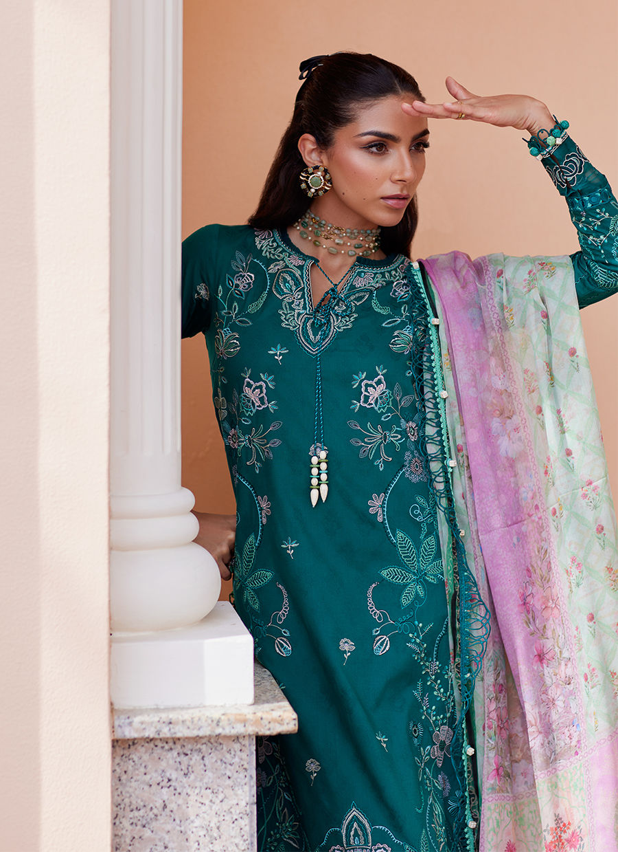 Model wearing Farah Talib Aziz Eileen Emerald green luxury unstitched dress with intricate embroidery. Shop Pakistani luxury pret online in the UK.