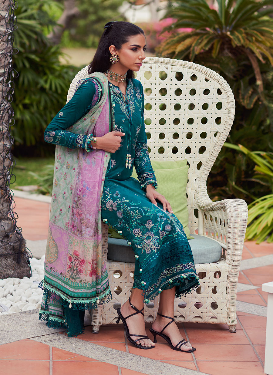 Model wearing Farah Talib Aziz Eileen Emerald green luxury unstitched dress with intricate embroidery. Shop Pakistani luxury pret online in the UK.