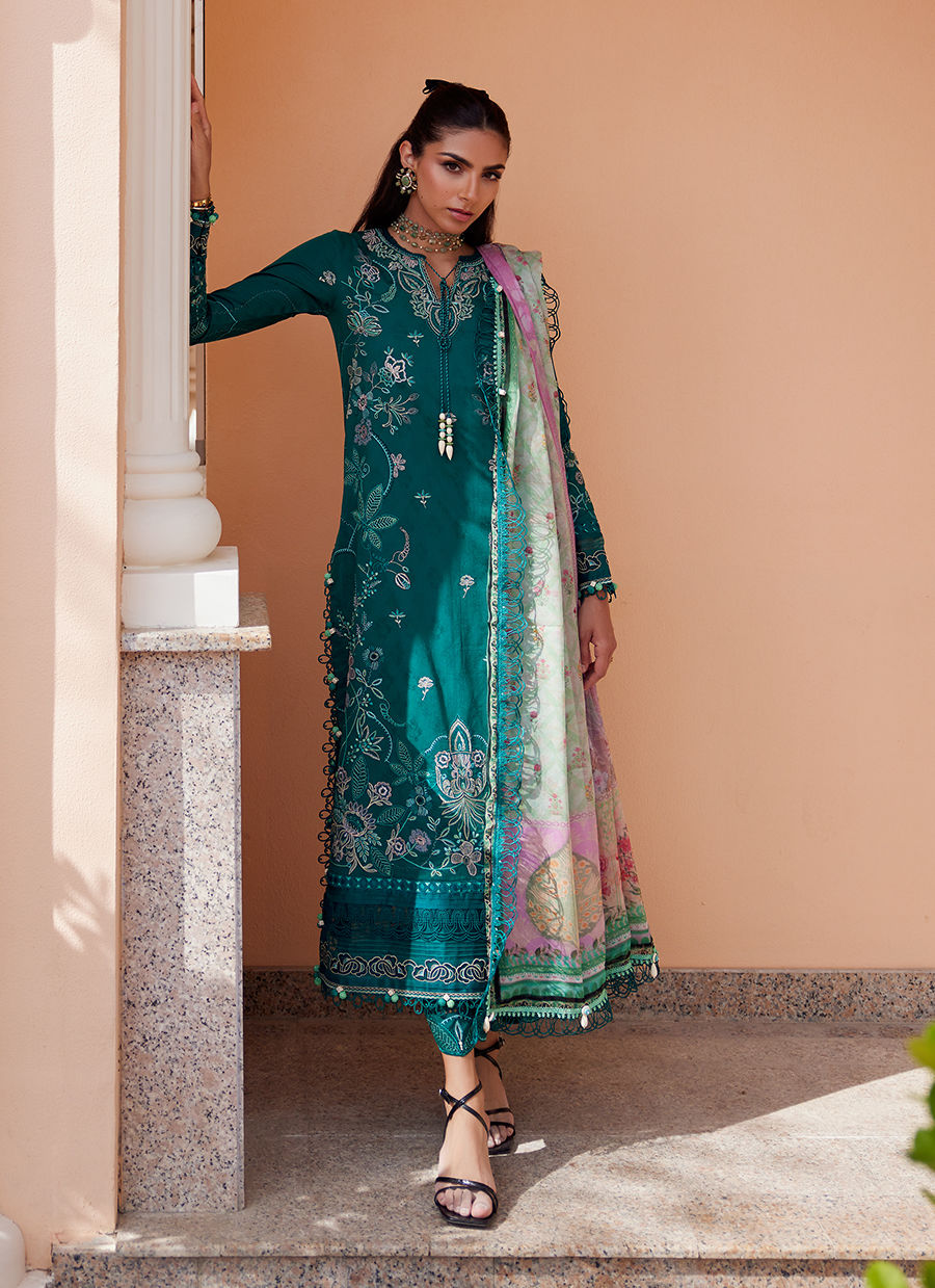 Model wearing Farah Talib Aziz Eileen Emerald green luxury unstitched dress with intricate embroidery. Shop Pakistani luxury pret online in the UK.