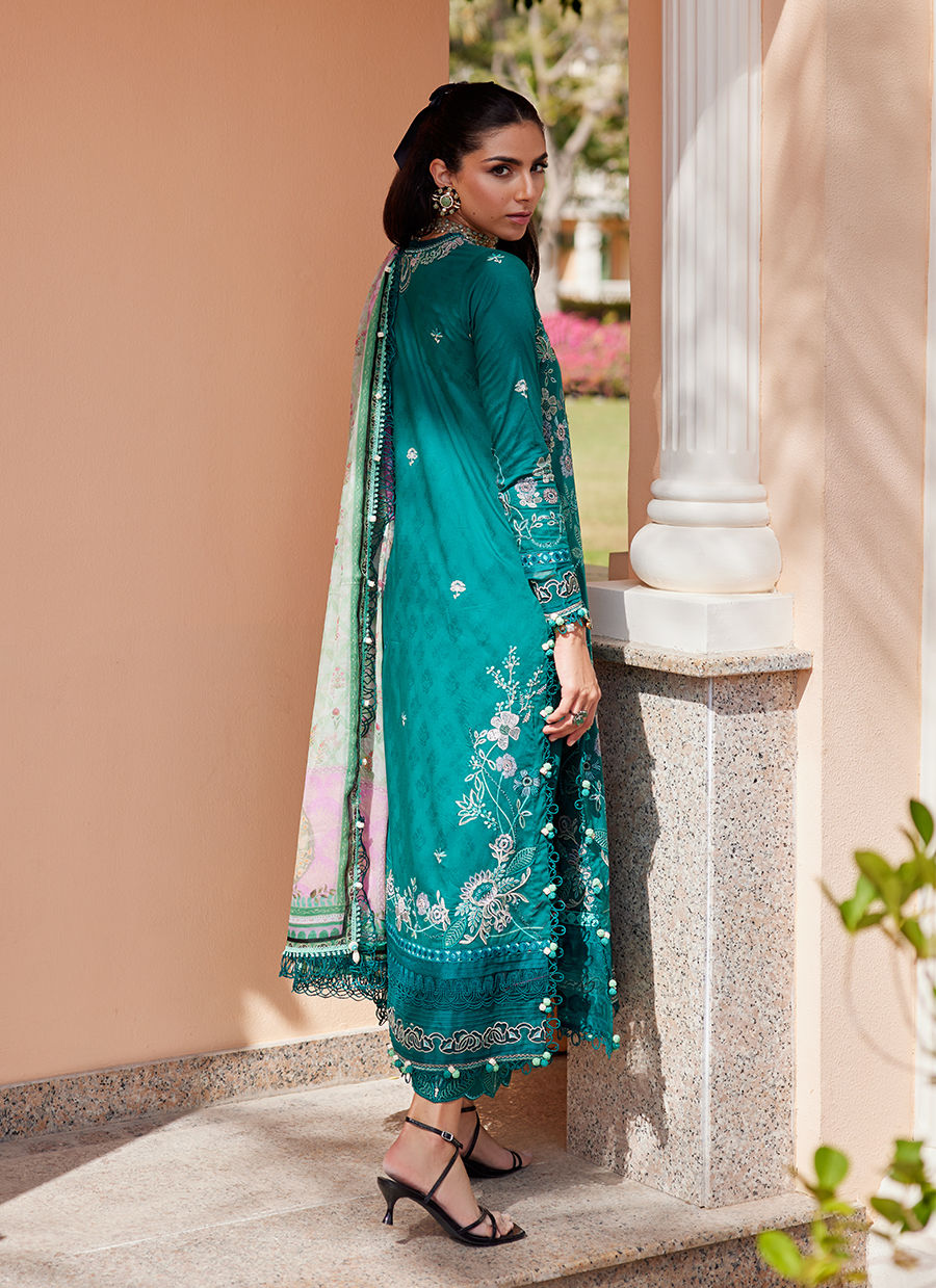 Model wearing Farah Talib Aziz Eileen Emerald green luxury unstitched dress with intricate embroidery. Shop Pakistani luxury pret online in the UK.