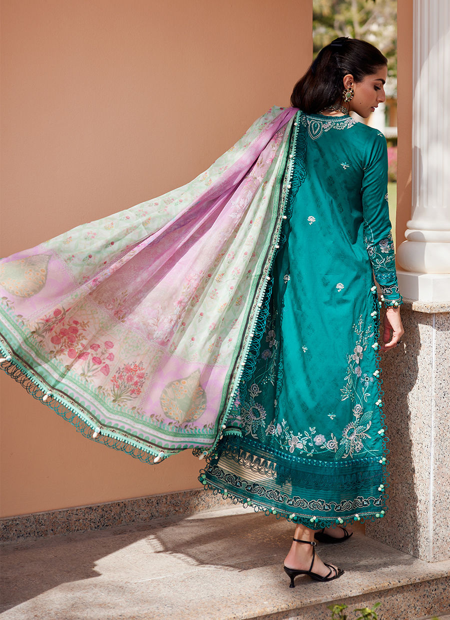 Model wearing Farah Talib Aziz Eileen Emerald green luxury unstitched dress with intricate embroidery. Shop Pakistani luxury pret online in the UK.