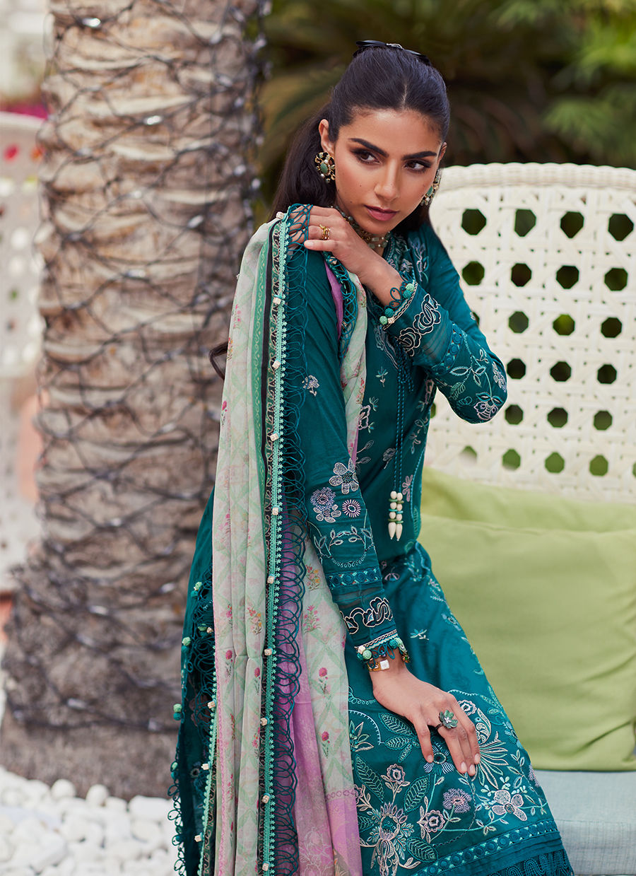 Model wearing Farah Talib Aziz Eileen Emerald green luxury unstitched dress with intricate embroidery. Shop Pakistani luxury pret online in the UK.